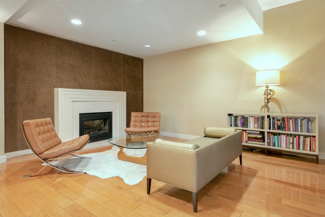 Resident lounge at The Anthem with fireplace and library
